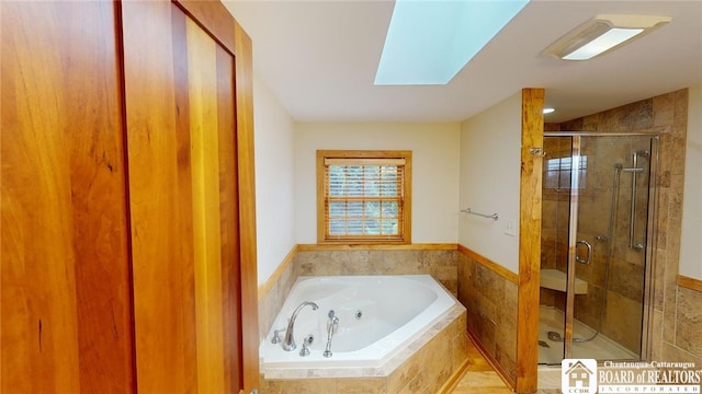 bathroom featuring a skylight and plus walk in shower