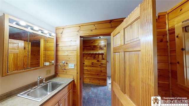 bathroom with wood walls and sink