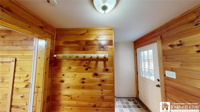 entryway featuring wood walls