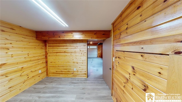 spare room with wooden walls and hardwood / wood-style flooring