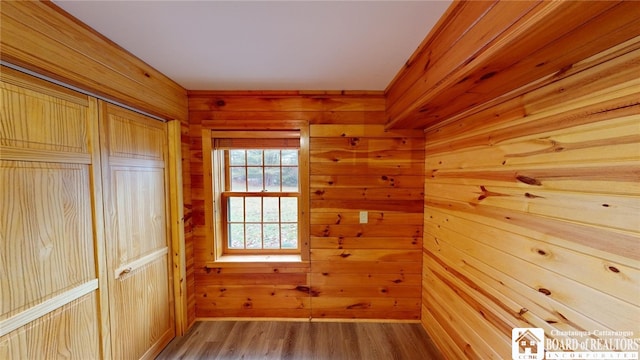 interior space featuring wood walls and hardwood / wood-style flooring