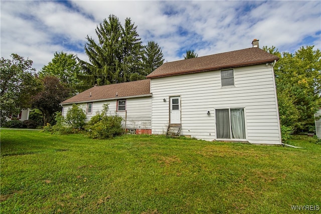 back of house featuring a yard