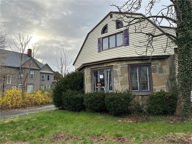 630 W Gray St, Elmira-City, NY 14905 - view of front facade featuring a gambrel roof, stone siding, and a front yard