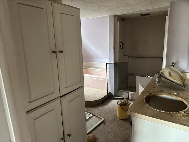 630 W Gray St, Elmira-City, NY 14905 - bathroom with double vanity, a garden tub, a shower stall, a textured ceiling, and tile patterned flooring