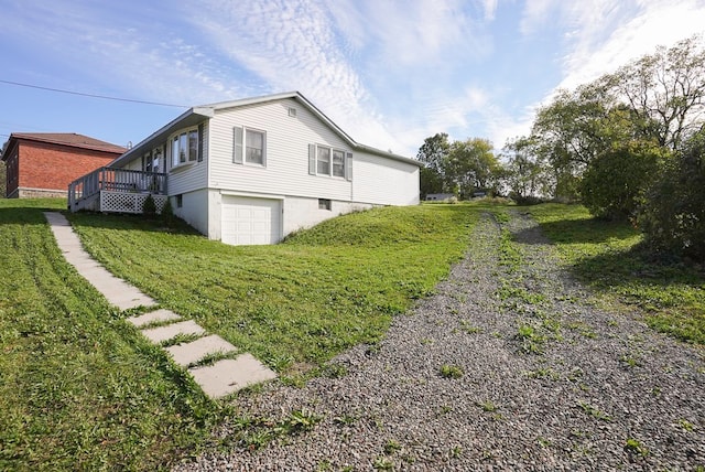 view of side of property with a wooden deck and a garage