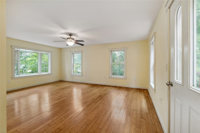 empty room with light hardwood / wood-style flooring and ceiling fan