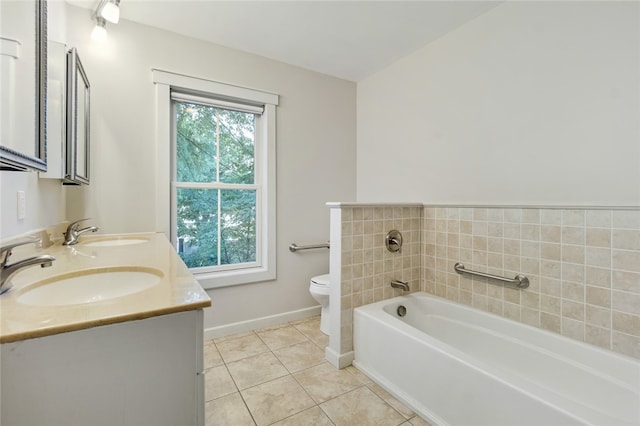 bathroom with vanity, tile patterned floors, a bathtub, and toilet