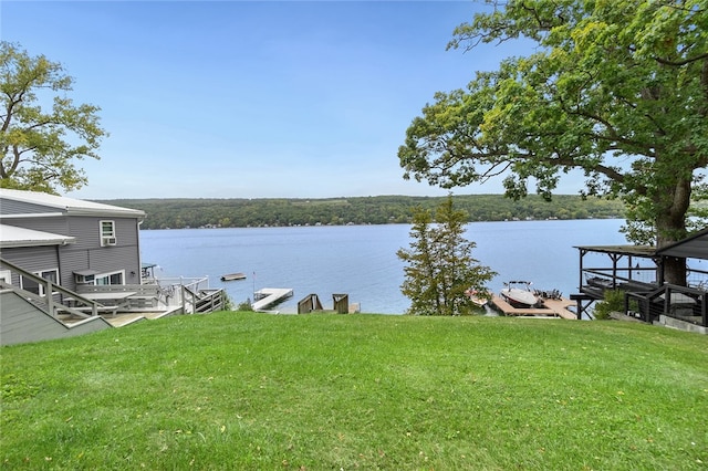 dock area featuring a water view and a yard