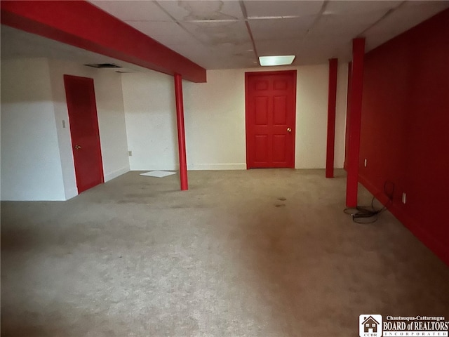 basement featuring carpet floors and a drop ceiling