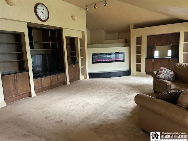 living room featuring vaulted ceiling, light carpet, and built in features