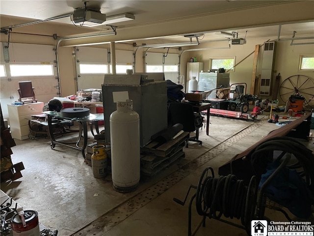 garage featuring a garage door opener and water heater