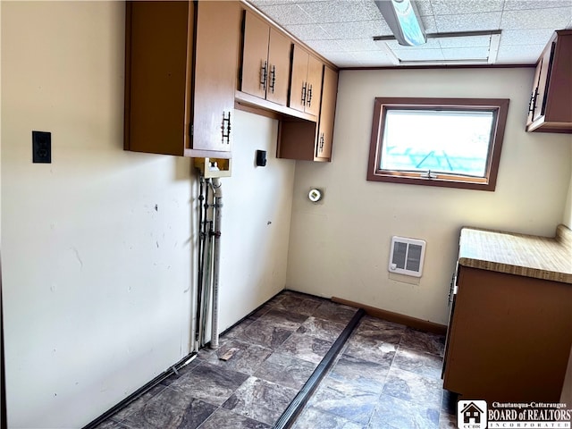 washroom with cabinets and heating unit