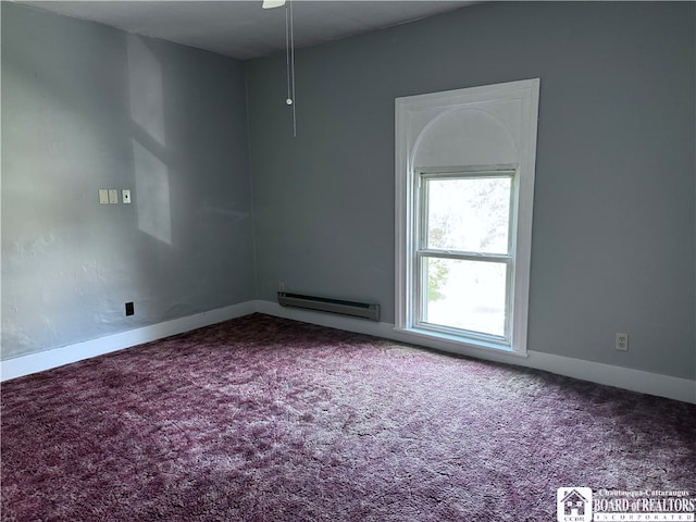 empty room featuring carpet and baseboard heating