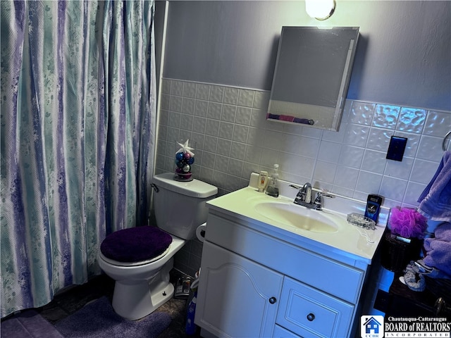 bathroom with vanity, tile walls, toilet, and a shower with shower curtain