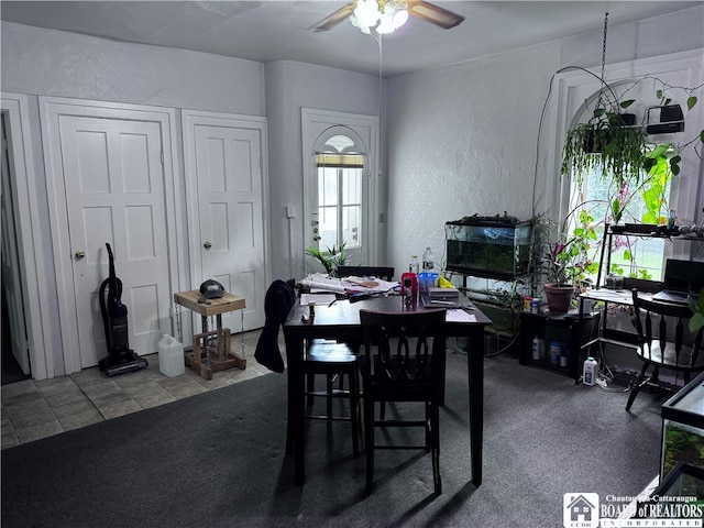 carpeted dining area with ceiling fan