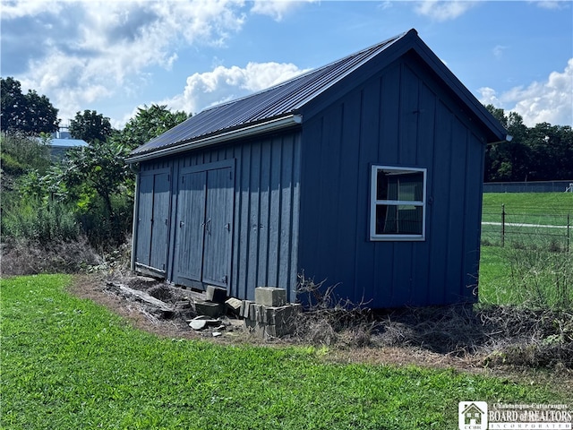 view of outbuilding with a yard