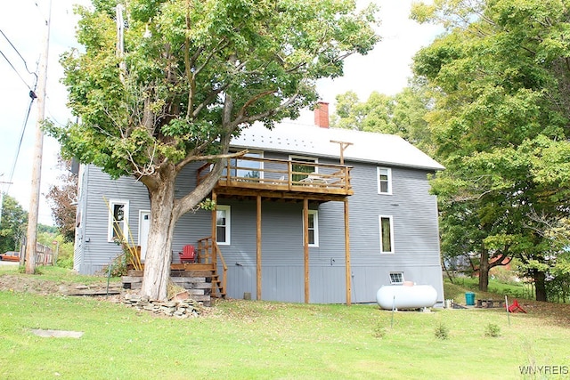 back of house featuring a deck and a yard