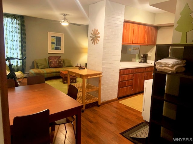 dining room with ceiling fan, a baseboard radiator, and light wood-type flooring