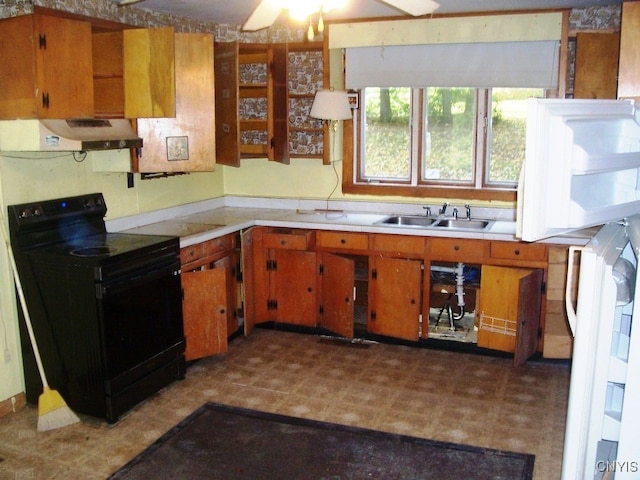 kitchen with black electric range oven, sink, and range hood