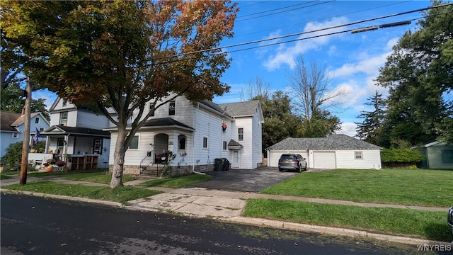 view of front of property featuring a garage, an outdoor structure, and a front lawn