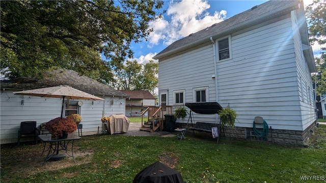 back of house with a lawn