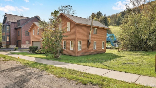 view of side of property featuring a lawn