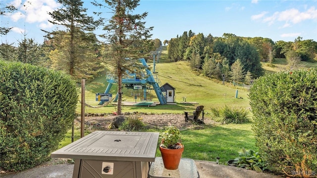 surrounding community featuring a playground and a lawn