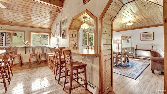 interior space with vaulted ceiling, wood ceiling, baseboard heating, and light hardwood / wood-style flooring