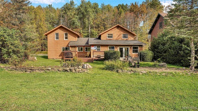 back of house featuring a deck and a yard