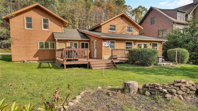 back of property with a lawn and a wooden deck