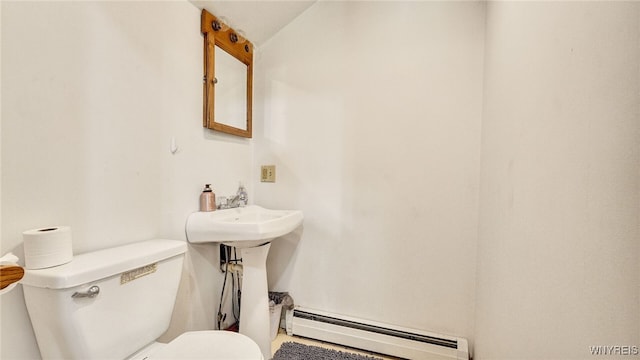 bathroom with a baseboard radiator and toilet