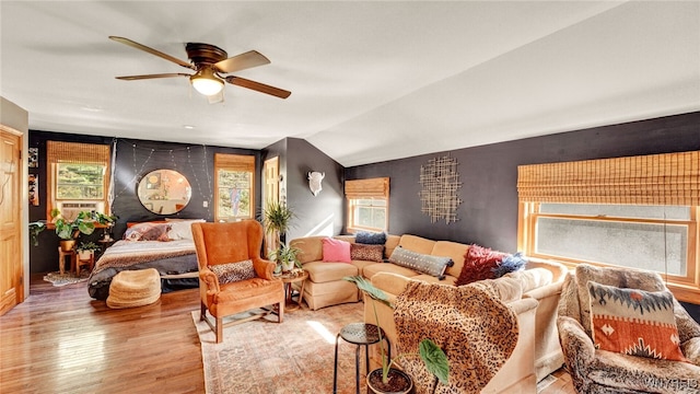 living room with light wood-type flooring, vaulted ceiling, and ceiling fan