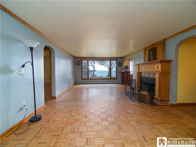 unfurnished living room featuring light parquet flooring and ornamental molding