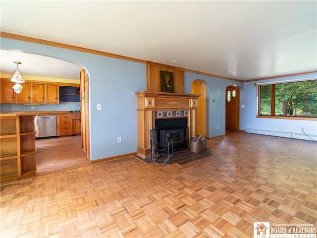 unfurnished living room featuring a baseboard radiator, light parquet flooring, ornamental molding, and sink