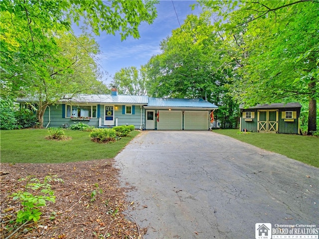 view of front of home featuring a garage and a front lawn