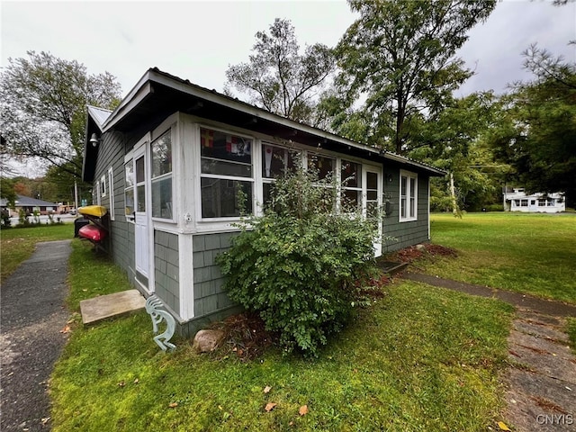 view of property exterior with a yard