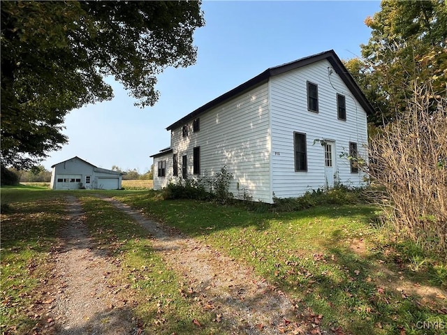 view of home's exterior featuring a garage and a lawn