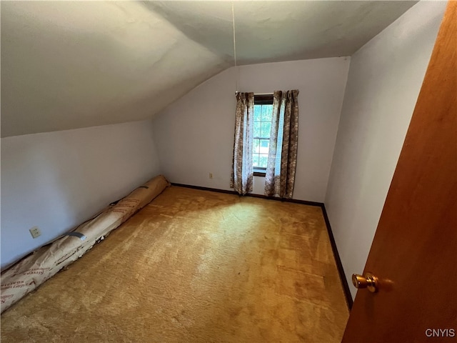 bonus room featuring vaulted ceiling and carpet