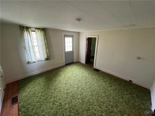 unfurnished room with a healthy amount of sunlight and carpet flooring