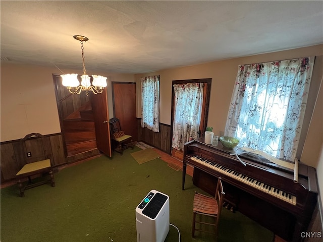 misc room with a chandelier and wooden walls