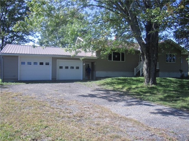 single story home featuring a front yard and a garage