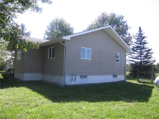 view of property exterior with a yard