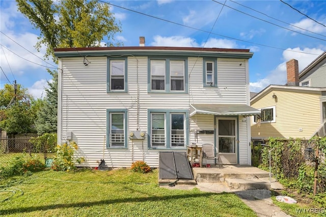 rear view of house with a patio area and a yard