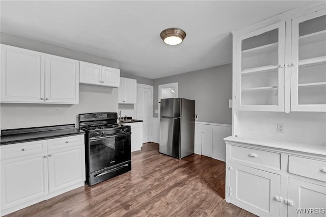 kitchen with white cabinetry, sink, gas stove, dark wood-type flooring, and stainless steel fridge