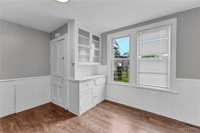 unfurnished dining area featuring hardwood / wood-style floors