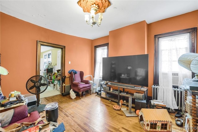 living room featuring an inviting chandelier and wood-type flooring