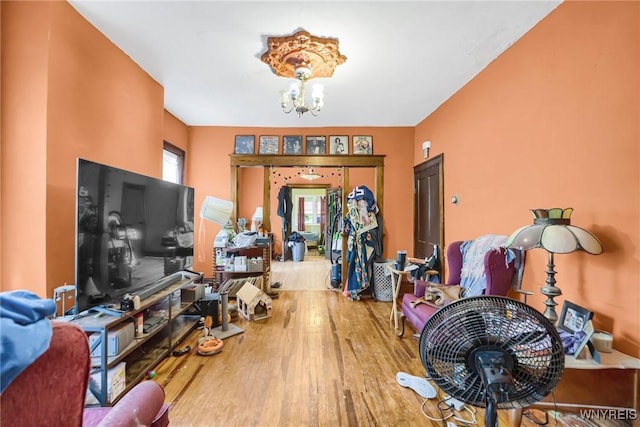 living room with hardwood / wood-style floors and an inviting chandelier