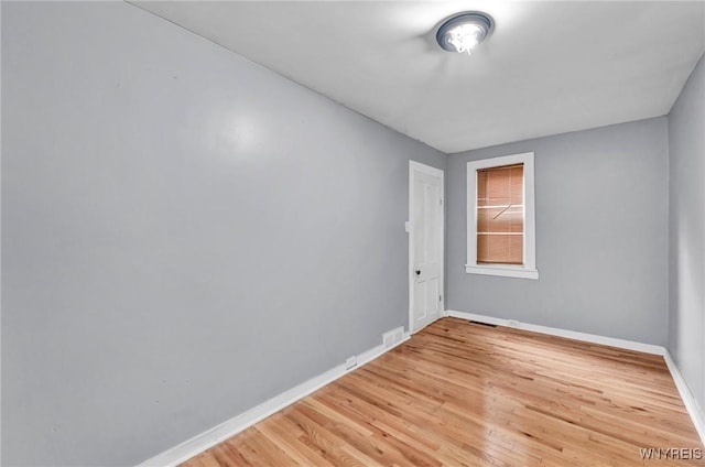 empty room with light hardwood / wood-style flooring