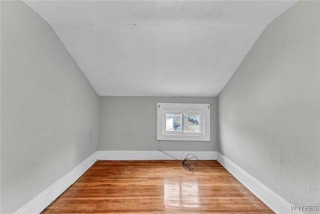 empty room featuring light hardwood / wood-style floors and lofted ceiling