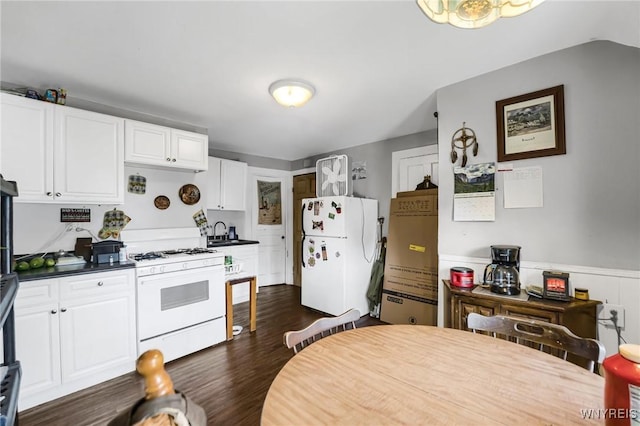 kitchen with sink, white appliances, white cabinets, and dark hardwood / wood-style flooring